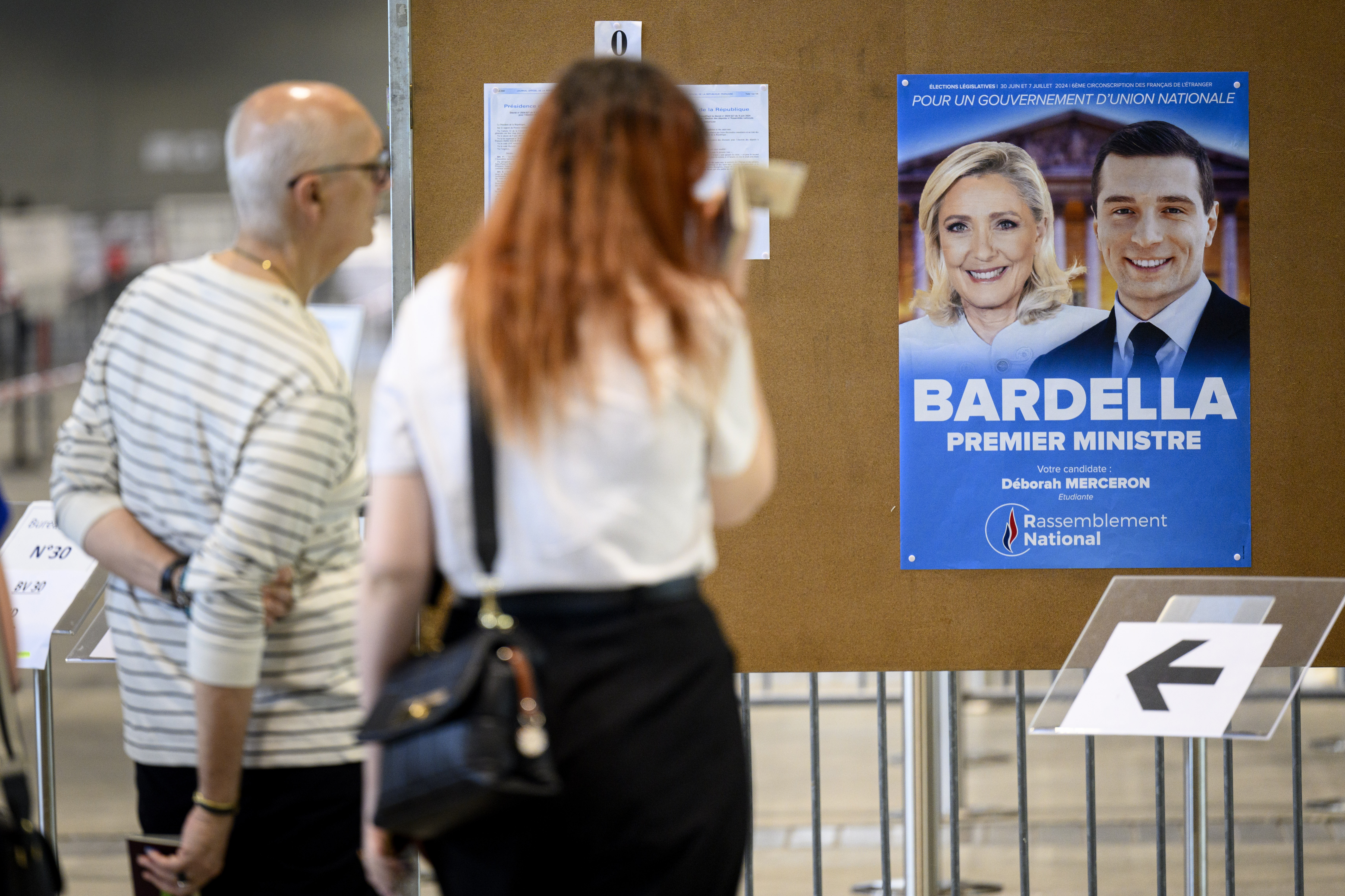 French far right wins first round of elections, Macron's alliance third
