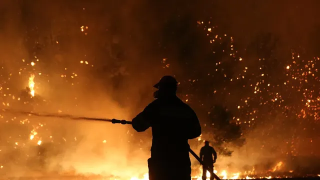 Firefighters battle to quell a blaze on the Greek island of Thassos