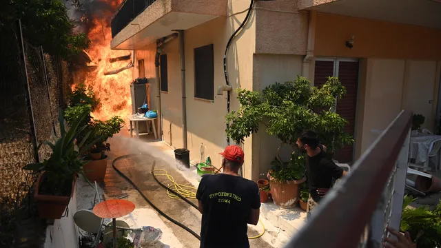 Thousands battle fires in Greece as heatwave grips Europe